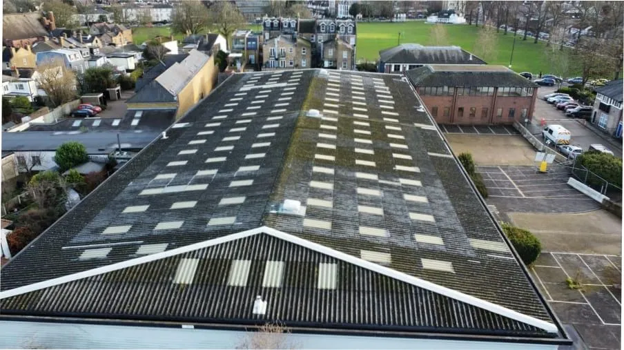 Asbestos roof replacement on a commercial building (illustrative)