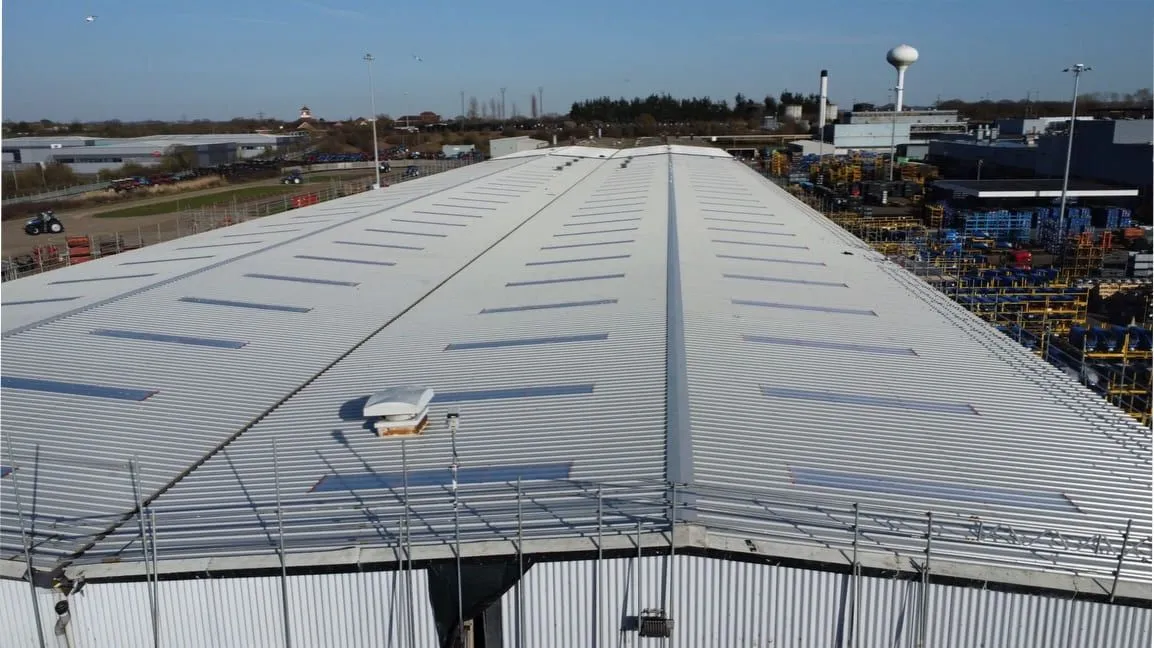 Aerial view of a large re-sheeted industrial roof (illustrative)