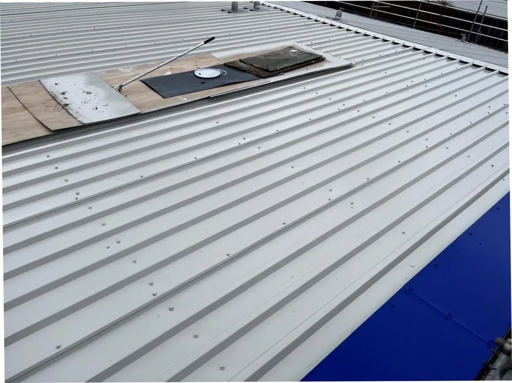 Industrial roof sheet replacement in progress (illustrative)